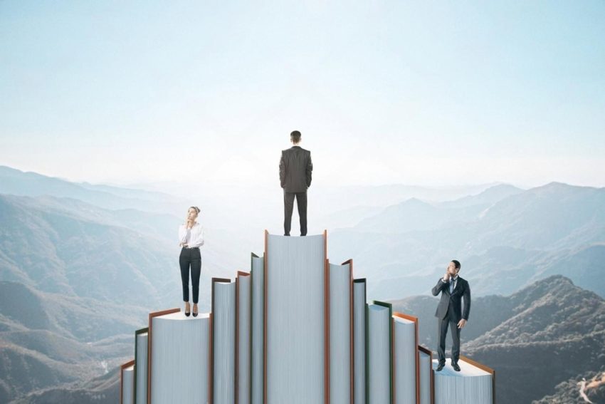 Students standing on stacked books above a mountain range, illustrating career progression through international qualifications