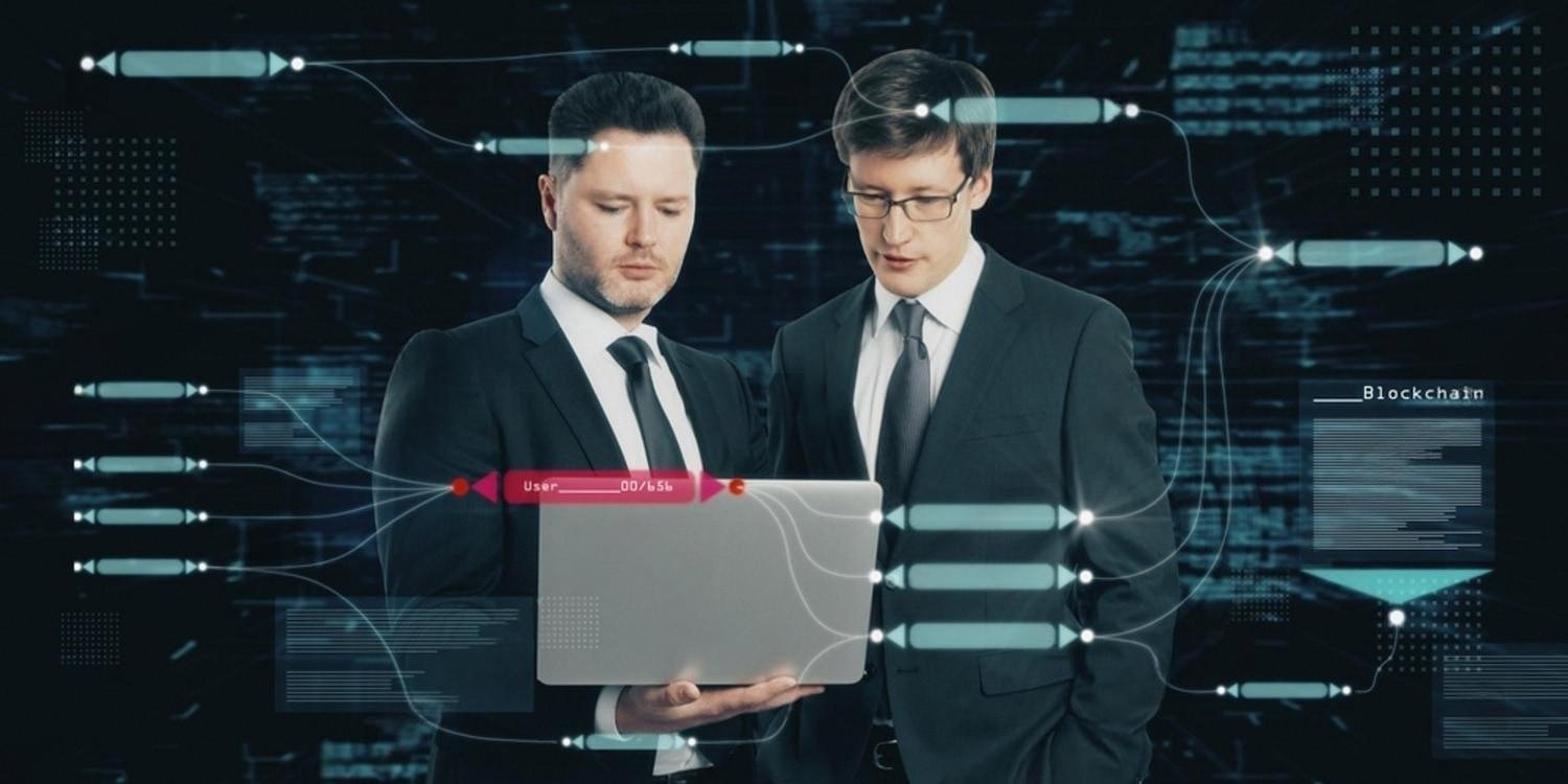 Two business students reviewing coursework on a laptop, representing OTHM and Qualifi training in the UAE